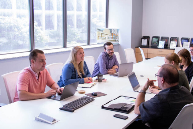 Customer success team gathered at a conference table.