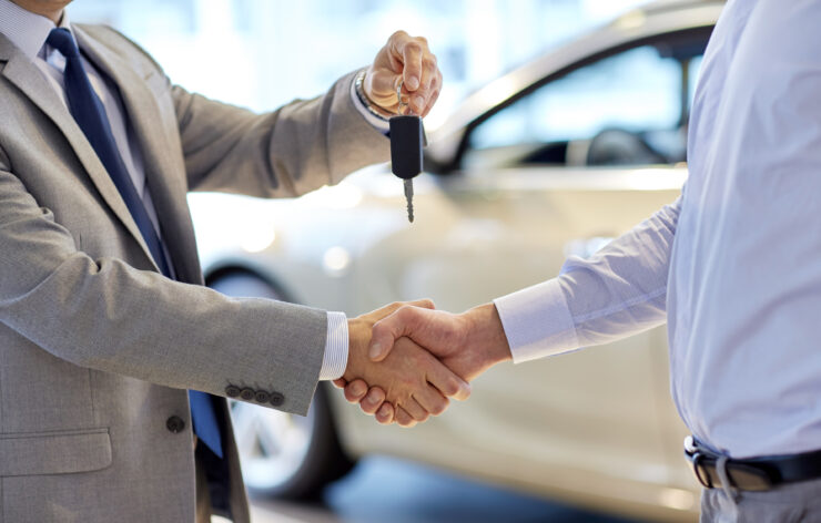 Handshake and handing over the car keys.